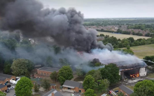 Black smoke enveloped surrounding buildings and residents were told to stay indoors