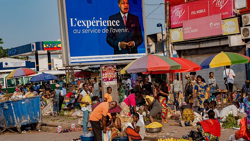 An election poster featuring President Denis Sassou N'Guesso stands over a market in central Brazzaville, Congo.