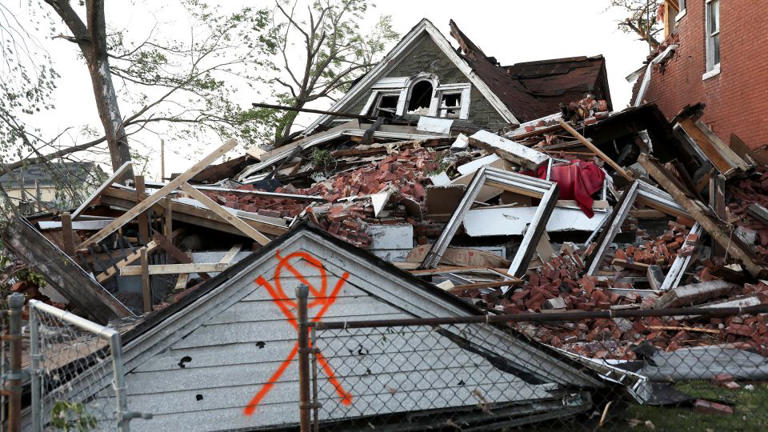 A house lies collapsed under a mountain of bricks, after a tornado struck in St. Louis, on Friday. - Lawrence Bryant/Reuters
