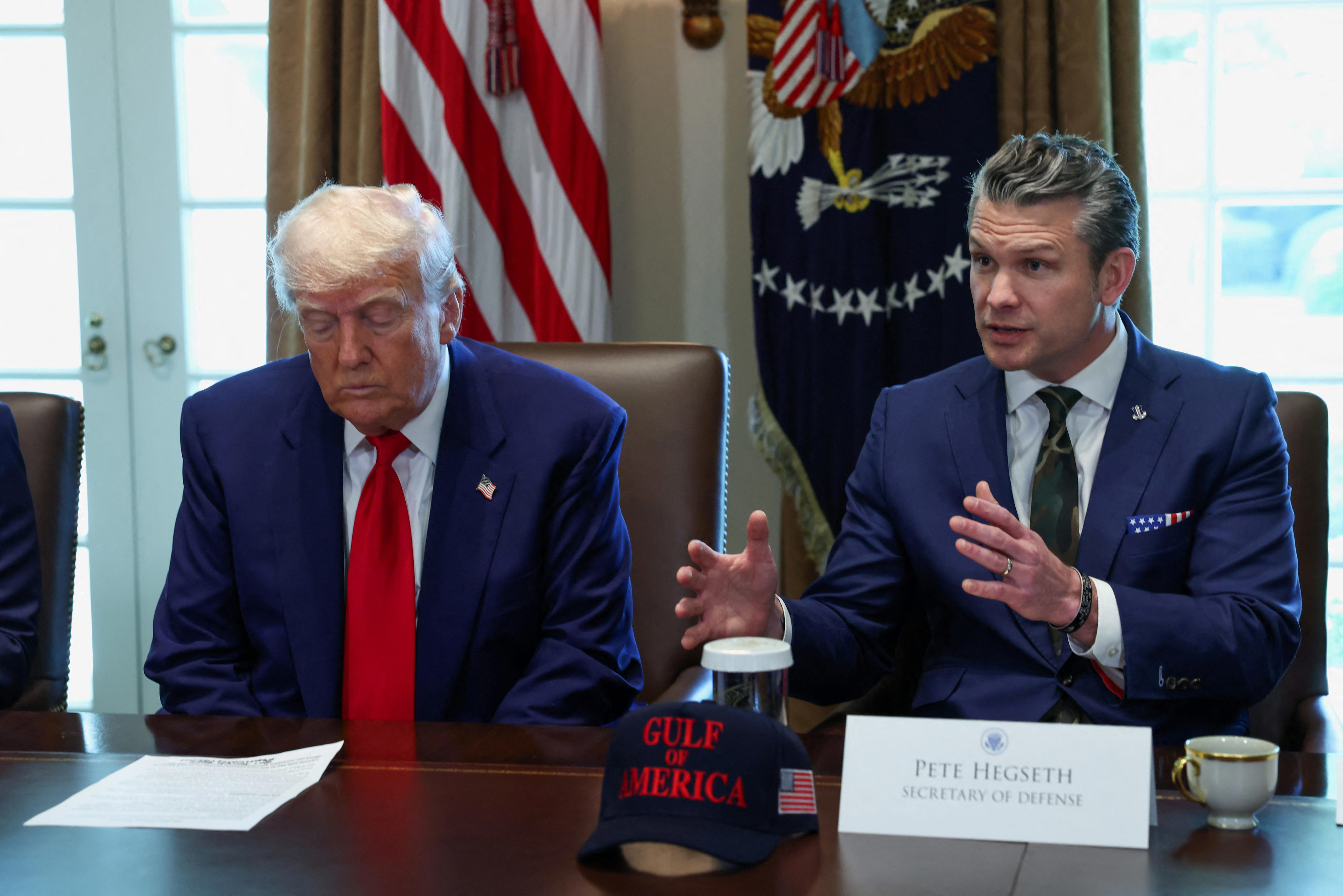 U.S. Defense Secretary Pete Hegseth speaks next to U.S. President Donald Trump during a cabinet meeting at the White House in Washington, D.C., U.S., April 30, 2025.