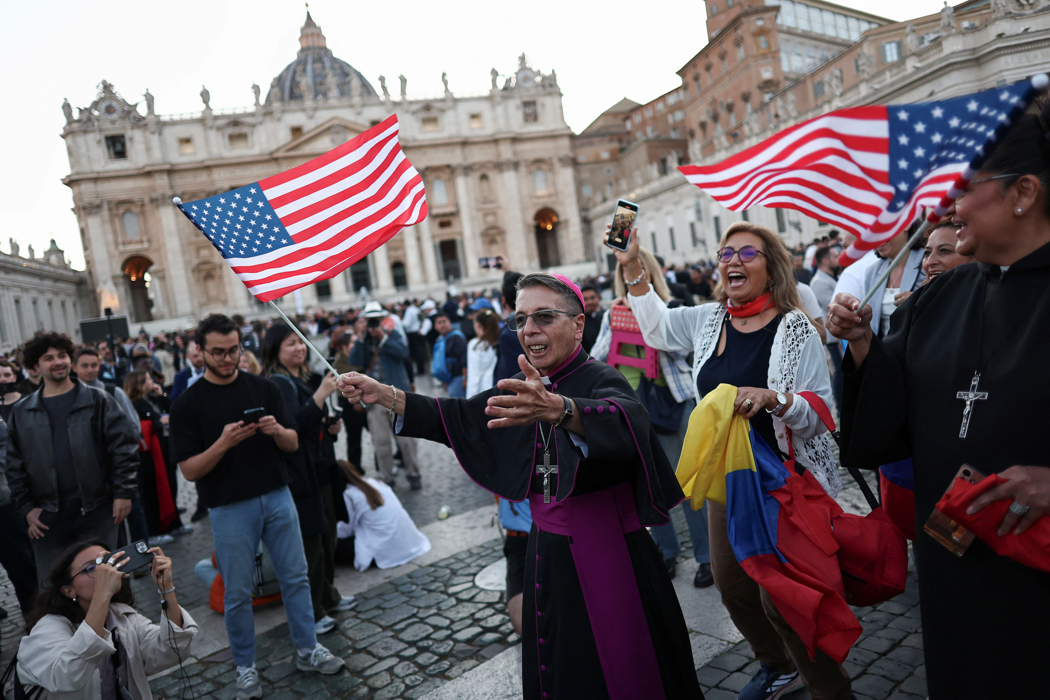 Onlookers wave American flags following the announcement that Chicago-born Prevost had been elected as the new pope (REUTERS)