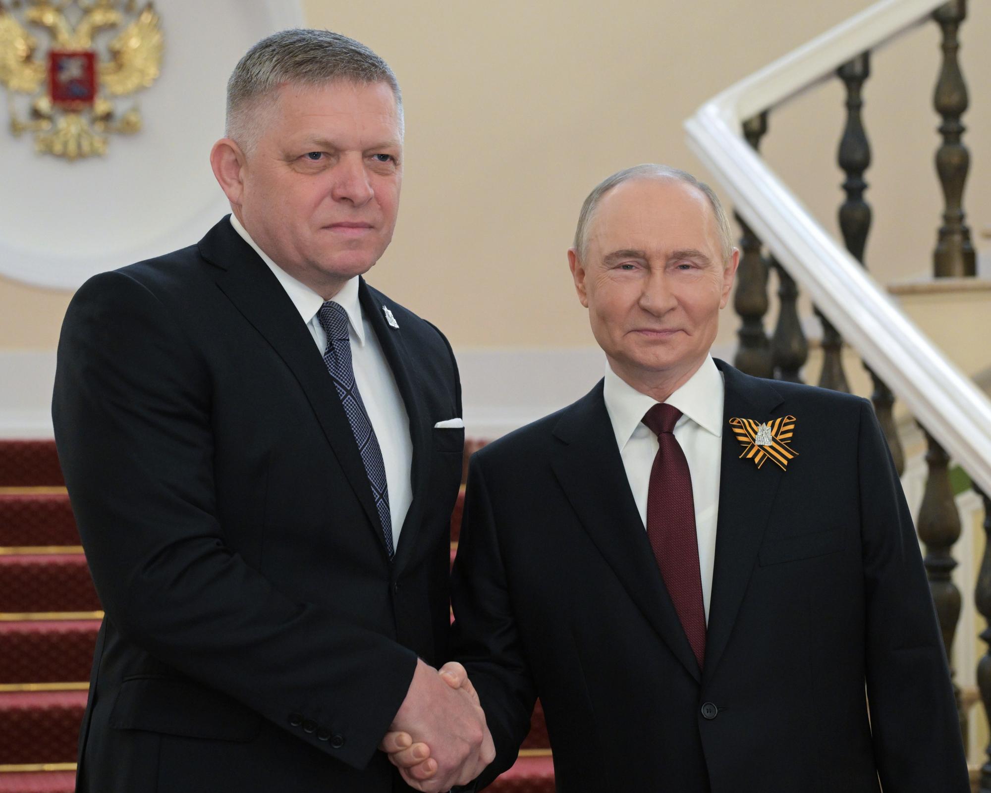 Robert Fico and Vladimir Putin shake hands before the Victory Day military parade in Moscow, Russia. Photograph: Alexei Nikolsky/AP