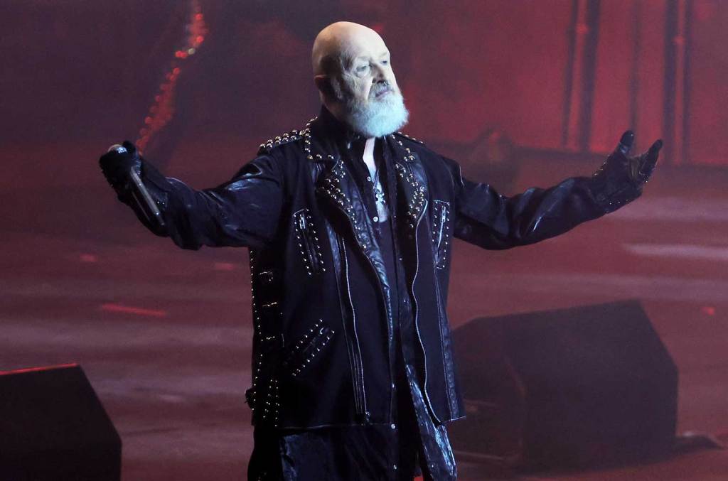Rob Halford in a classic heavy metal moment, captivating the audience with his performance.