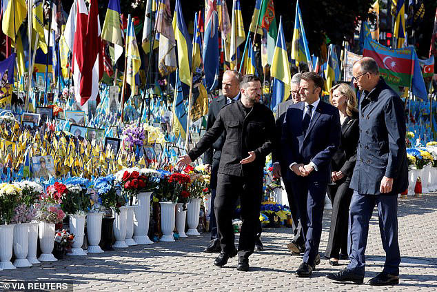 Poland's Prime Minister Donald Tusk, Starmer, Zelensky and First Lady Olena Zelenska, Macron, and Merz pay their respects to the victims of war at the Memorial for the Fallen at the Independence Square