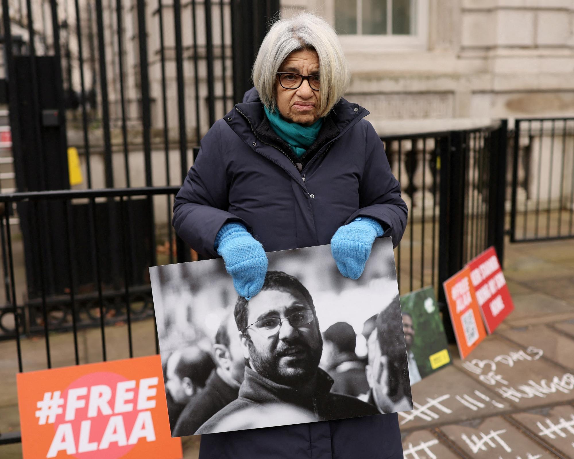 Laila Soueif with a photo of her son during a protest outside Downing Street in London in January. Photograph: Isabel Infantes/Reuters