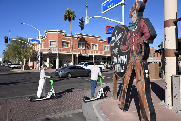SCOTTSDALE, AZ – NOVEMBER 19: People ride electric scooters through the old town area on Tuesday November 19, 2024 in Scottsdale, AZ. Maricopa County continues to be one of the fastest growing areas in the country. (Photo by Matt McClain/The Washington Post via Getty Images)