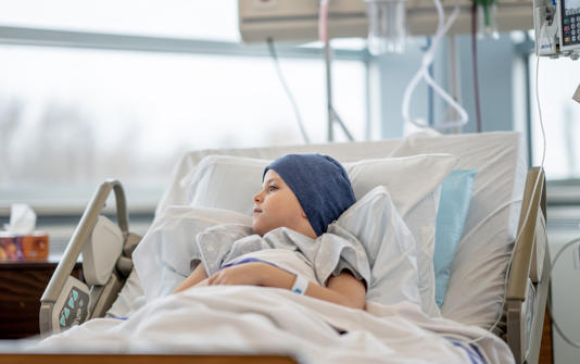 Young cancer patient in hospital bed