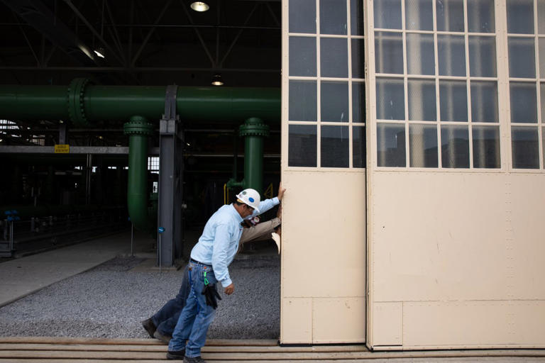 Williams employees opening a hangar door at the company’s Brooklyn, N.Y., facility.