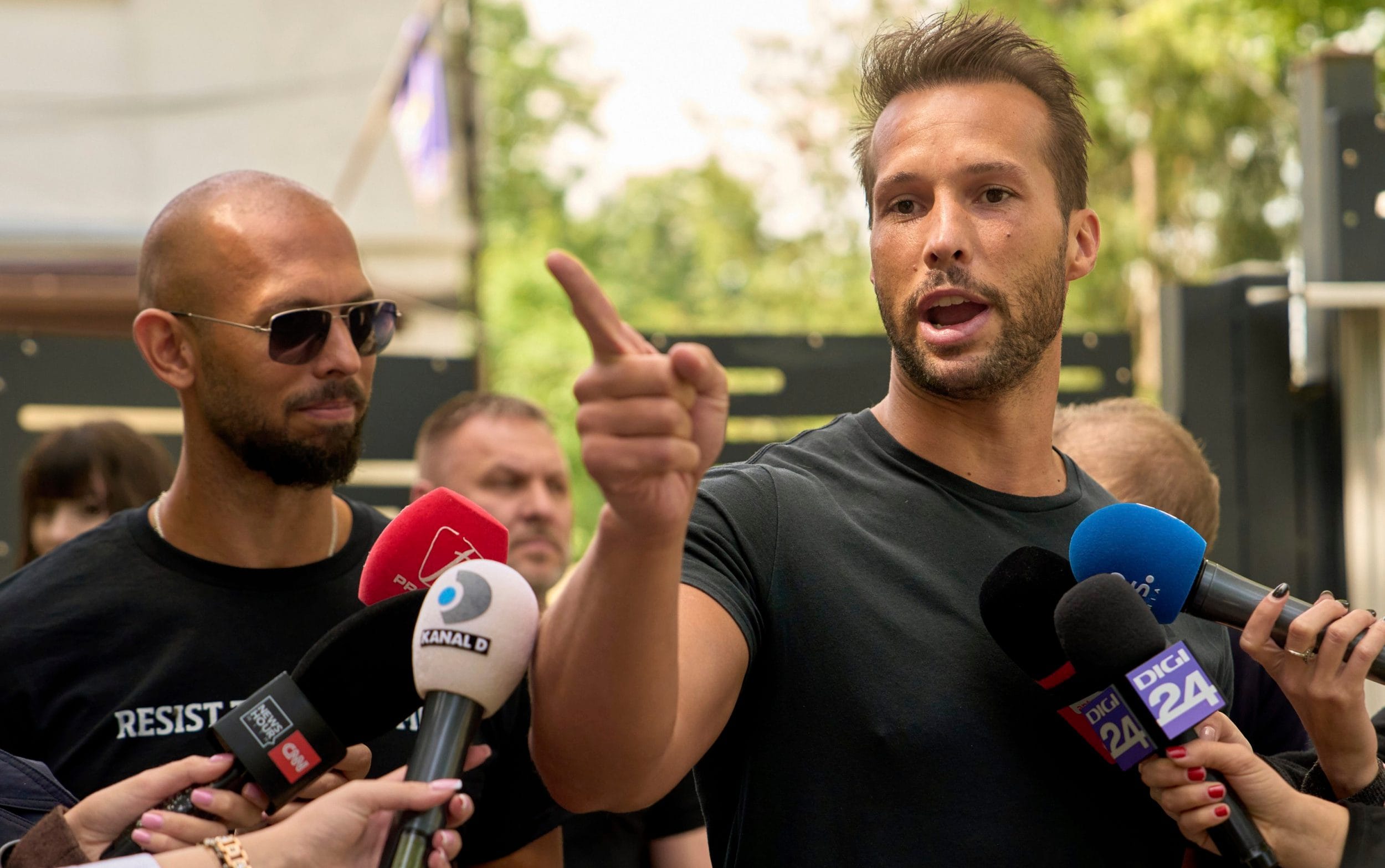 Andrew (L) and Tristan Tate plan to defend themselves against more than 20 charges of rape and human trafficking, their lawyer has said - Vadim Ghirda