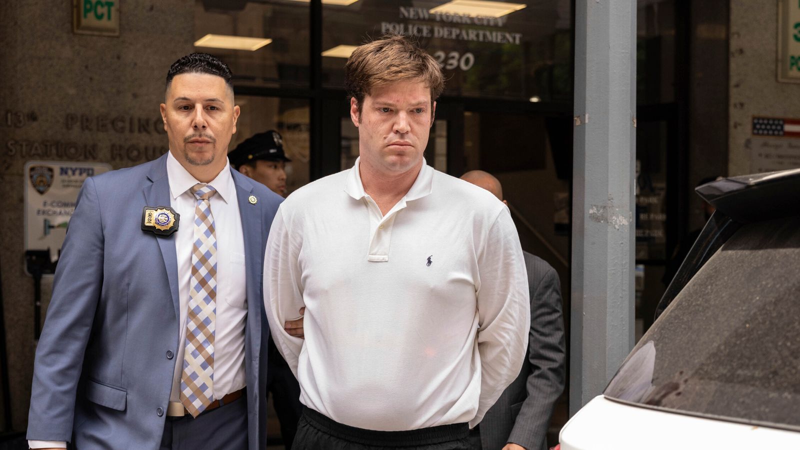William Duplessie is escorted out a New York police station. Pic: AP