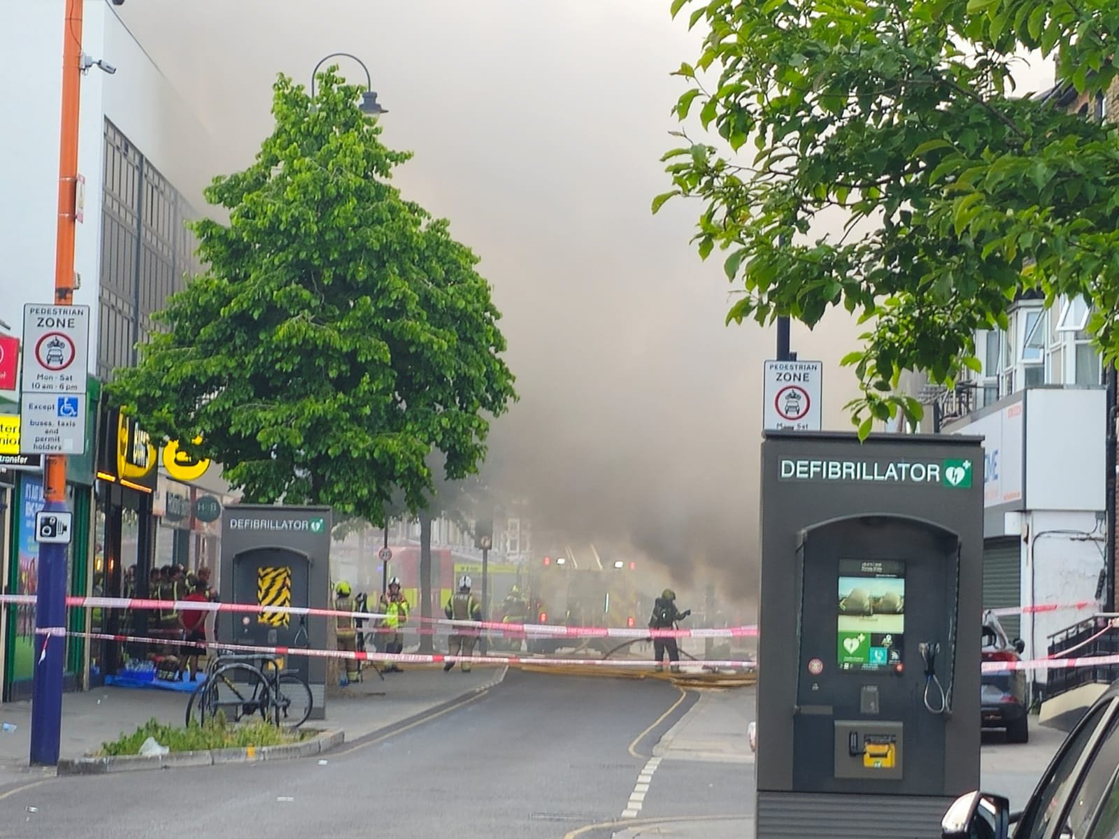 Huge fire at shop in East London fills the sky with smoke