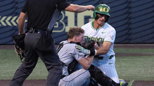 Oregon’s Anson Aroz, right, collides with Utah Valley catcher Mason Strong at the plate in the eighth inning of the Eugene NCAA Regional at PK Park. | Chris Pietsch/The Register-Guard / USA TODAY NETWORK via Imagn Images