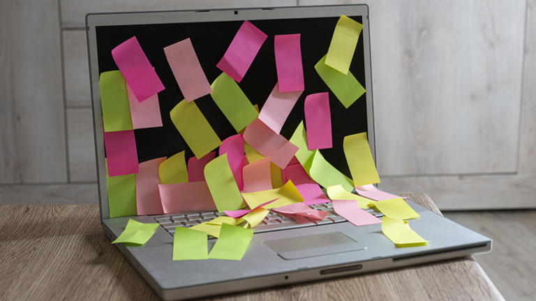 Laptop covered in sticky notes