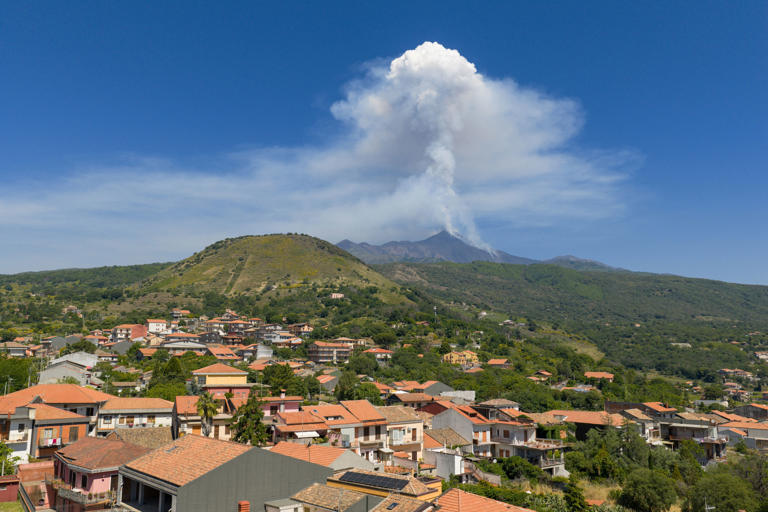 A drone view shows volcanic stream rising from Mount Etna, as seen from Milo, Italy (Reuters)