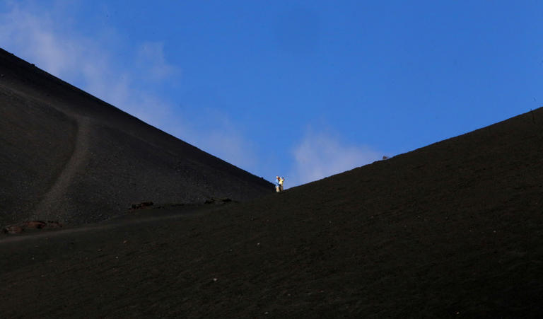 Tourists take selfies as they tour Mount Etna (REUTERS)