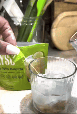 Mixing a cocktail with ice using a packet labeled