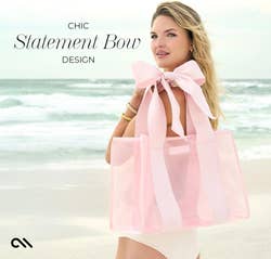 Model on beach with large pink tote, featuring a prominent bow and matching accessories. Text highlights