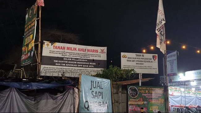 Lahan sengketa di Tangsel yang dipasangi banner dari Grib Jaya dan plang dari Polda Metro Jaya.