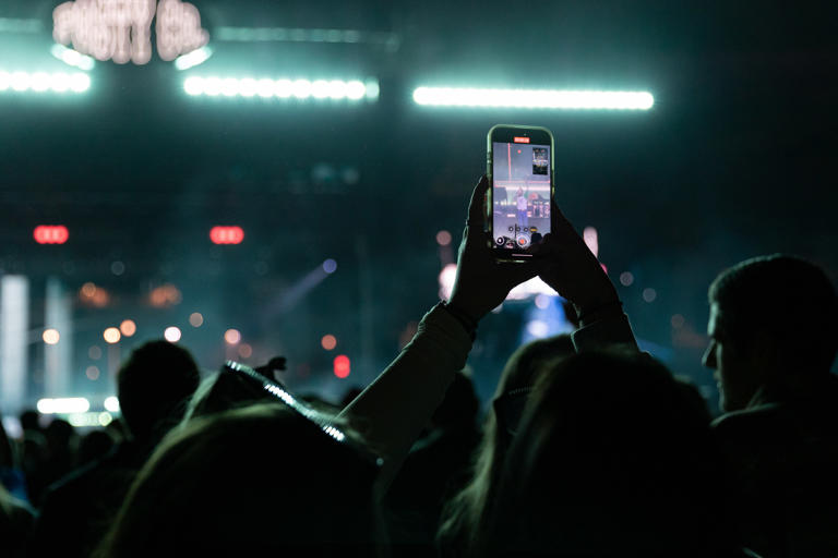 A fan takes a video as Post Malone performs during the Big Ass Stadium Tour at Citizens Bank Part in Philadelphia, Pa. on Saturday, May 24, 2025.