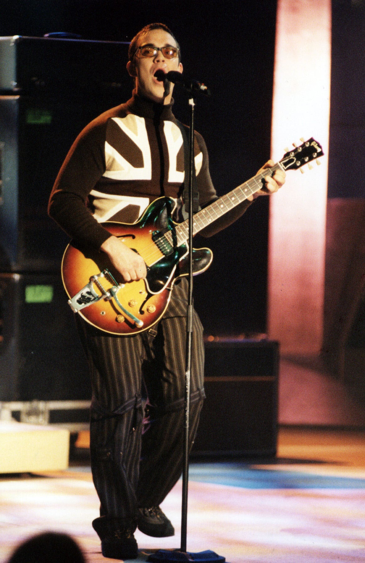 Williams in a Union Jack polo on stage in 1997 (Fiona Hanson/PA)