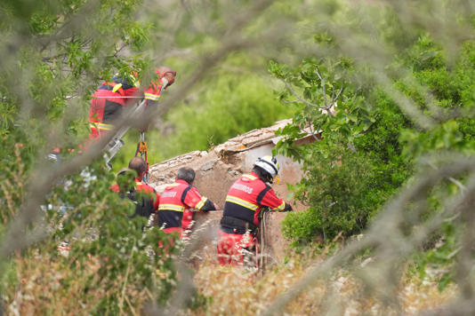 Firefighters and search teams check a well during the search on Tuesday (James Manning/PA Wire)