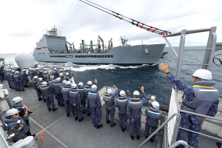 FILE PHOTO: Crewmembers of Japanese Maritime Self Defense Force training vessel JS Kashima wave towards the U.S. Navy oiler USNS Harvey Milk during an exercise in the Virginia Capes’ (VACAPES) operating area in the Atlantic Ocean, September 24, 2024. LaShawn Sykes/U.S. Navy/Handout via REUTERS/File Photo