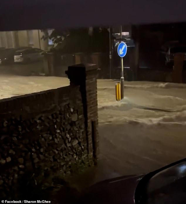 Video footage shows floodwater moving down a residential road in Dover on Friday night