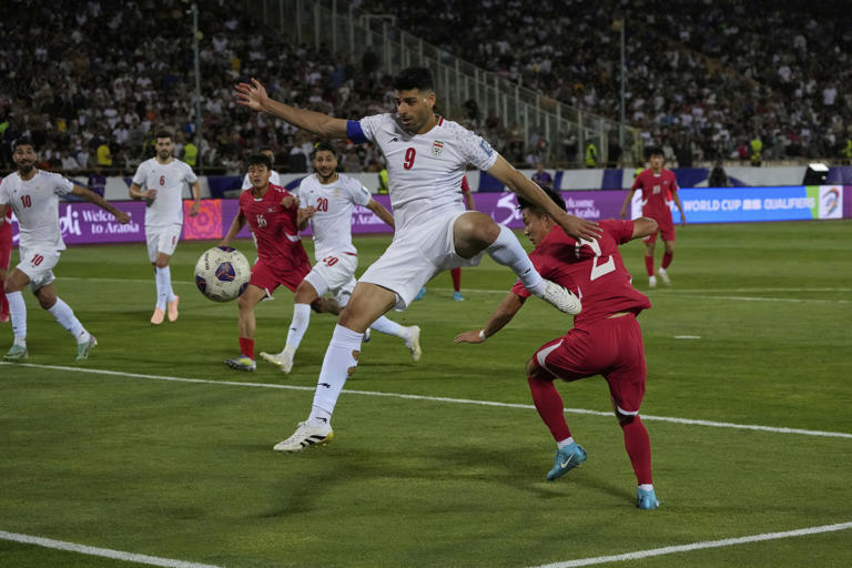 Iran's Mehdi Taremi shoots the ball during the 2026 World Cup Asian qualifier group A soccer match between Iran and North Korea, at Azadi Stadium in Tehran, Iran, Tuesday, June 10, 2025. (AP Photo/Vahid Salemi)