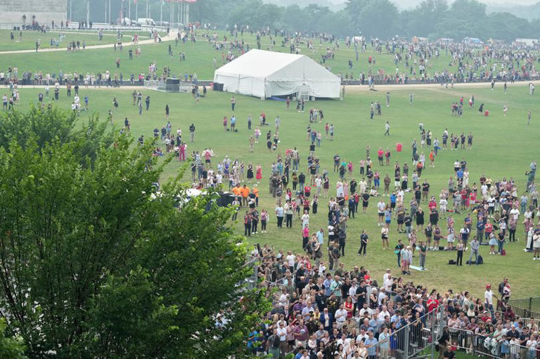 People attend a military parade commemorating the Army's 250th anniversary and coinciding with President Donald Trump's 79th birthday, Saturday, June 14, 2025, in Washington.