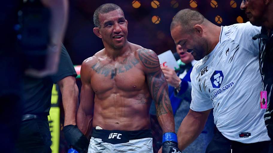 Jan 18, 2025; Inglewood, California, USA; Raoni Barcelos (blue gloves) reacts after defeating Payton Talbott (not pictured) during UFC 311 at Intuit Dome. Mandatory Credit: Gary A. Vasquez-Imagn Images | Gary A. Vasquez-Imagn Images