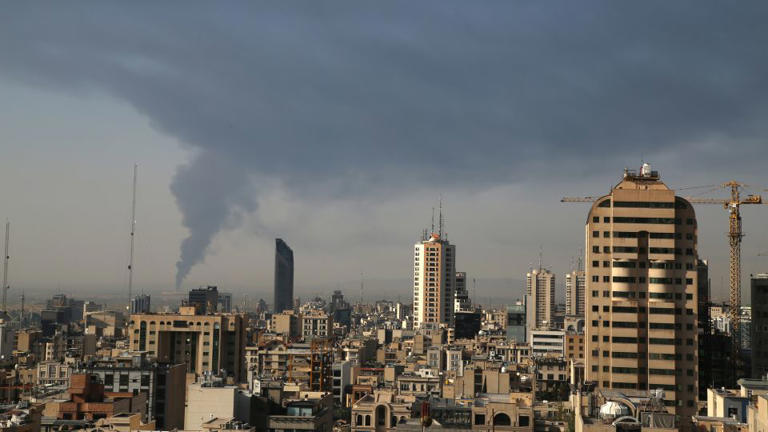 Huge smoke rises up from an oil facility facility after it appeared to have been hit by an Israeli strike Saturday in southern Tehran. - Mohammad Ghadamali/AP