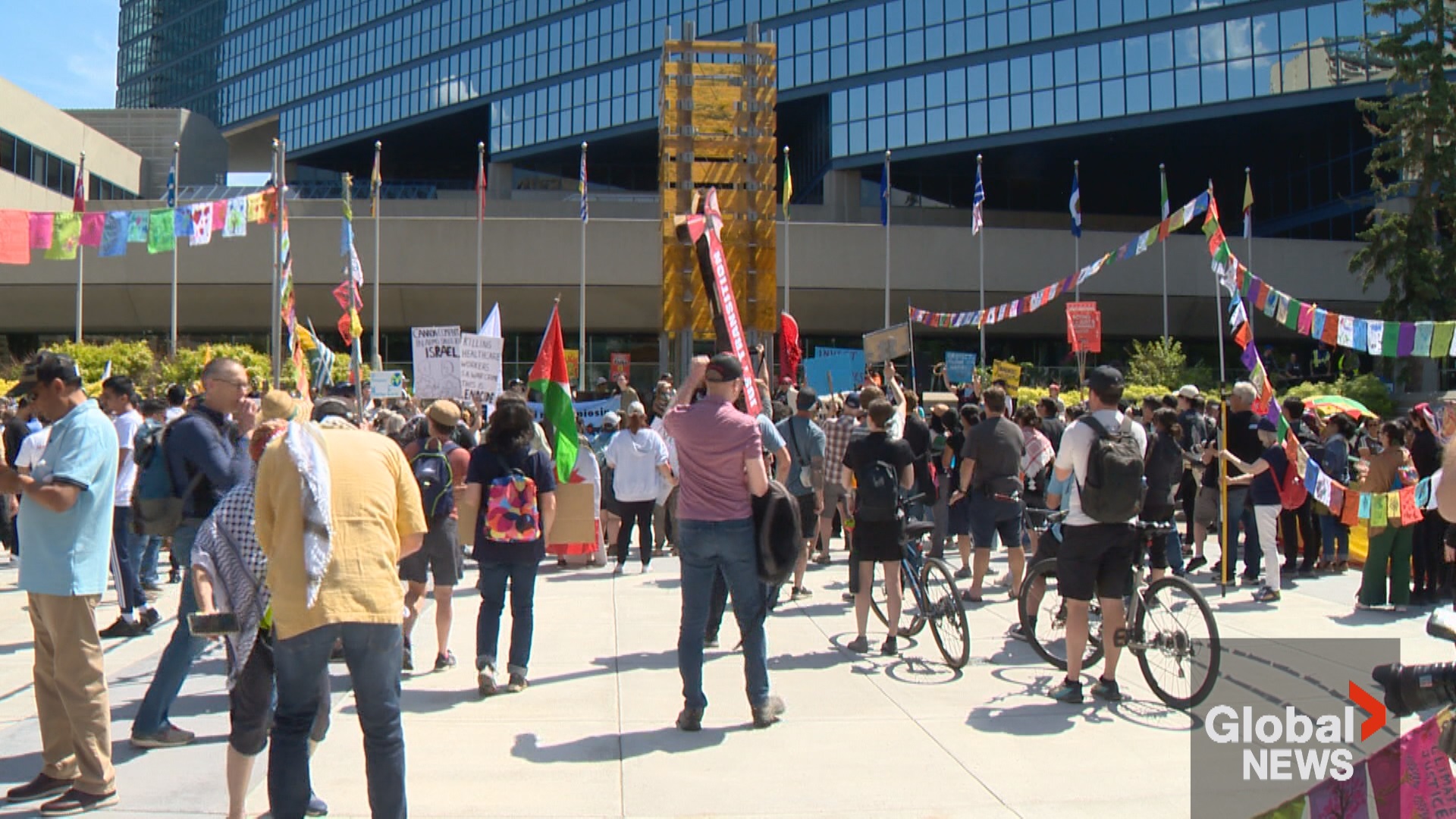 Hundreds of demonstrators gather peacefully at Calgary city hall as the