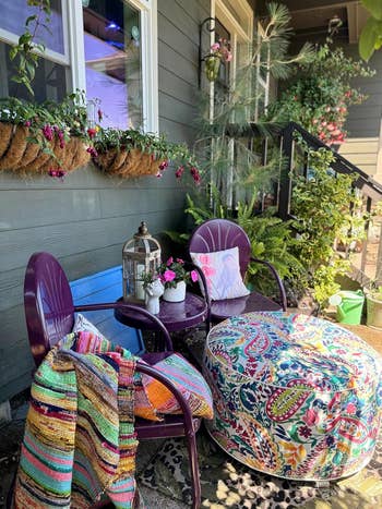 the colorful ottoman next to chairs and plants