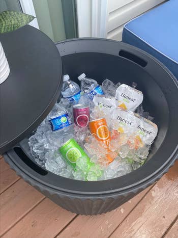 Large cooler filled with ice and various bottled beverages