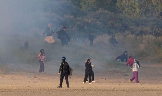 French police have used tear gas against migrants on a beach. 