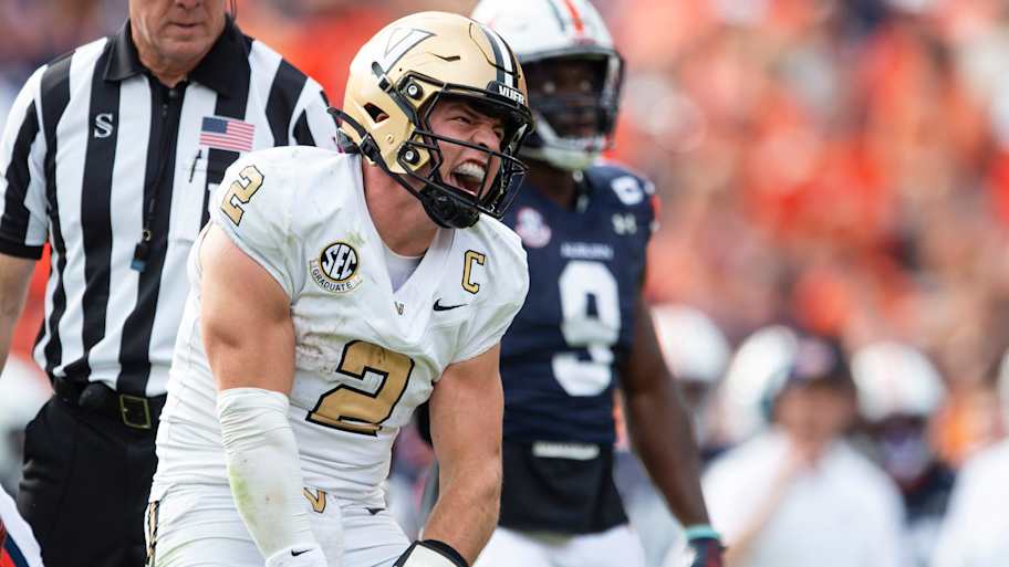 Vanderbilt quarterback Diego Pavia in action, displaying strong emotions on the field during a college football game.