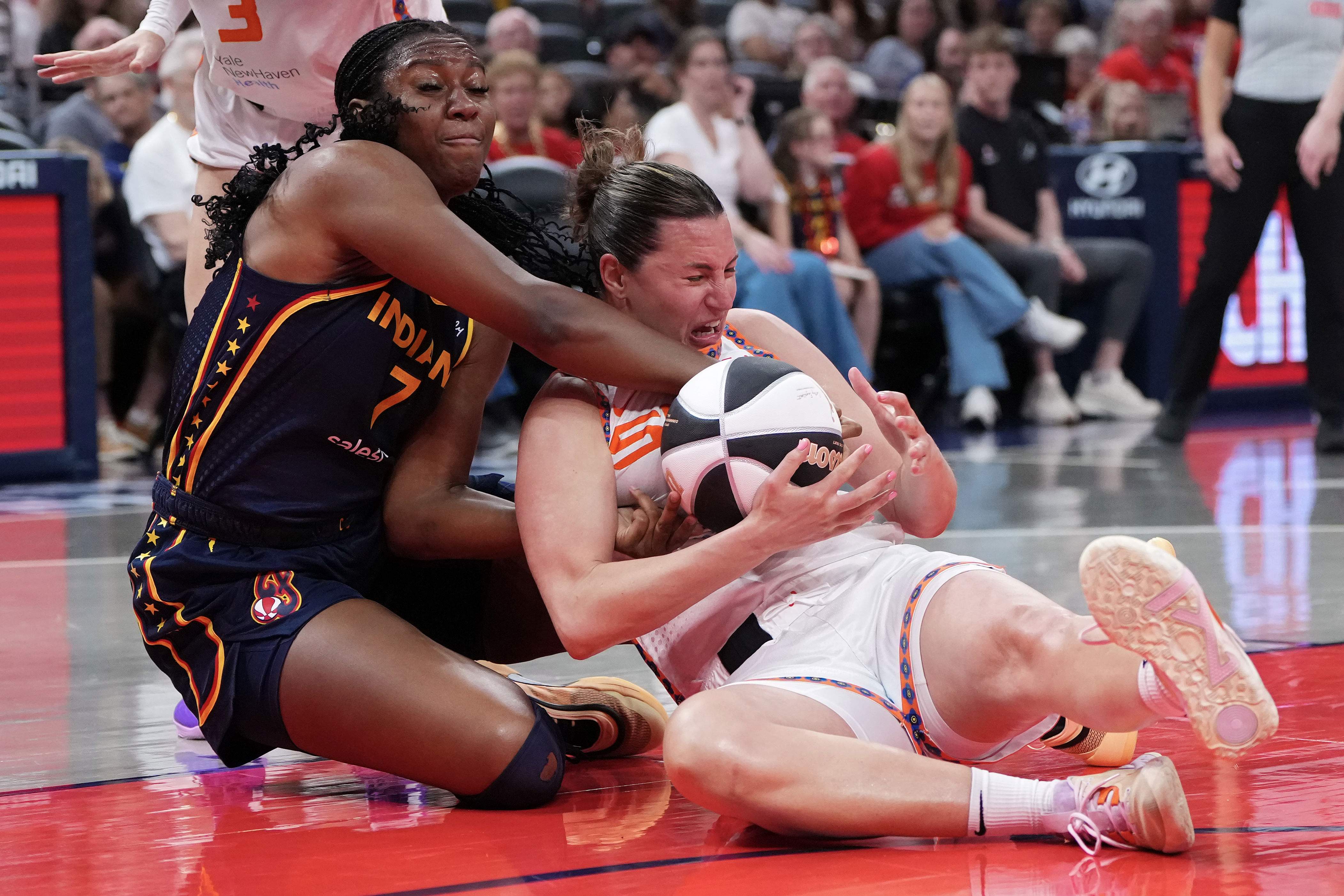 Aliyah Boston of the Fever battles with the Sun's Haley Peters for the ball. (Dylan Buell/Getty Images)