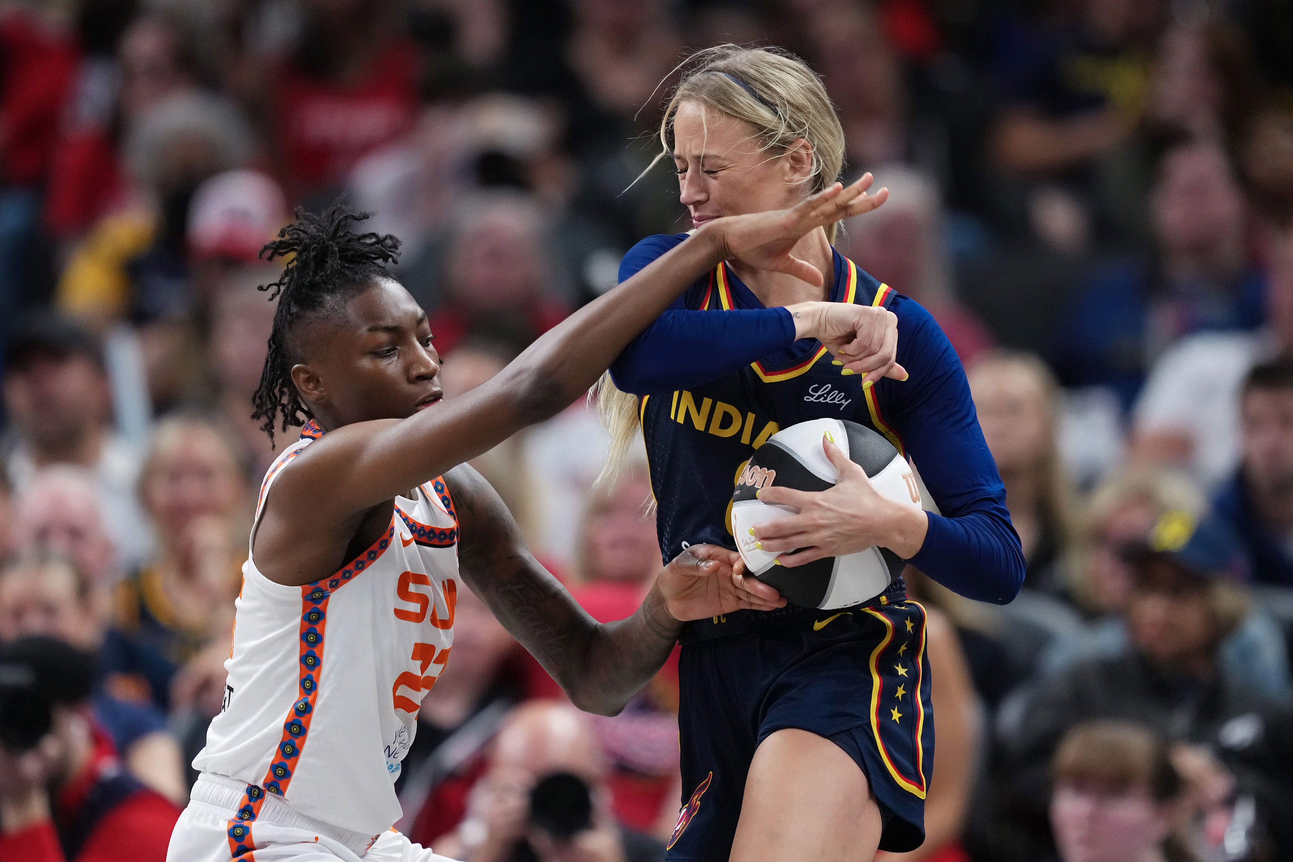 Sophie Cunningham of the Indiana Fever drives against the Sun's Saniya Rivers. (Dylan Buell/Getty Images)