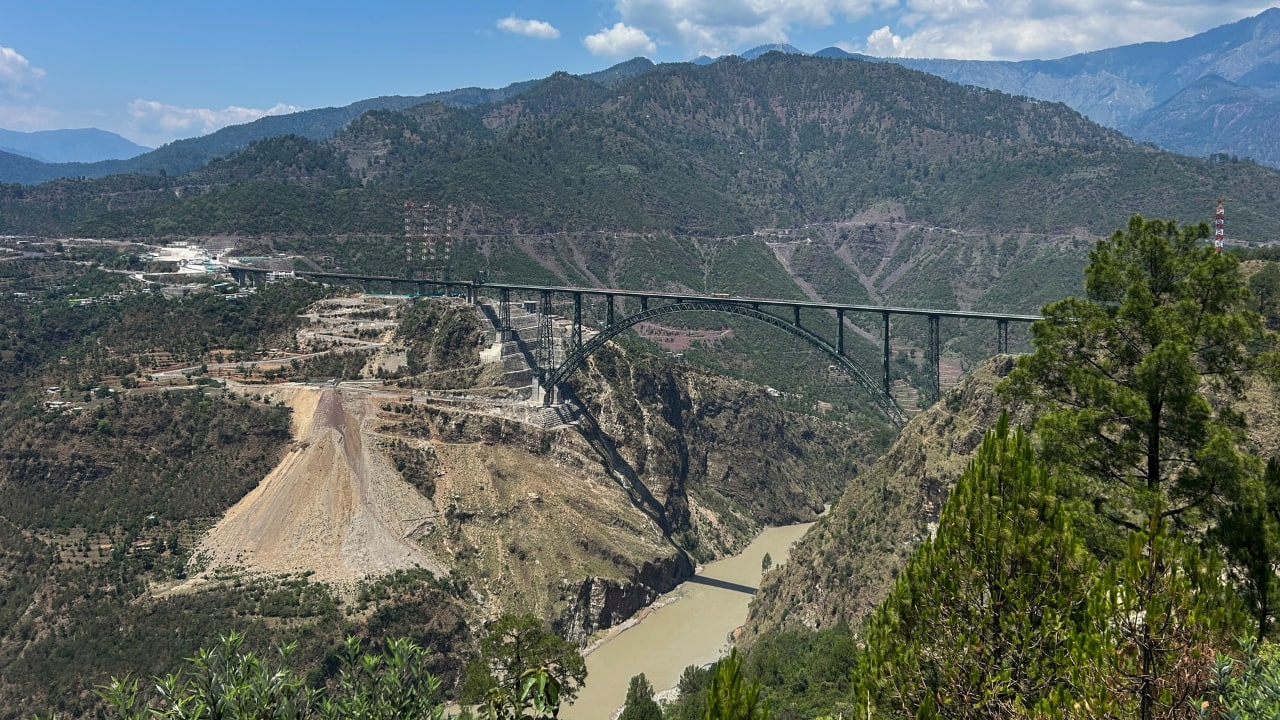 Chenab Bridge: Engineering Wonder Taller Than Eiffel Tower The Chenab Railway Bridge stands at an awe-inspiring height of 359 metres above the Chenab River, making it 35 metres taller than the Eiffel Tower. Located between Bakkal and Kauri in the Reasi district, this arch bridge spans 1,315 metres and uses a 467-metre steel arch as its centerpiece. As part of the Katra–Sangaldan stretch of the USBRL, the bridge provides uninterrupted rail connectivity to the Kashmir Valley for the first time in Indian history, revolutionizing transport and integration in the region. (Image: PTI)