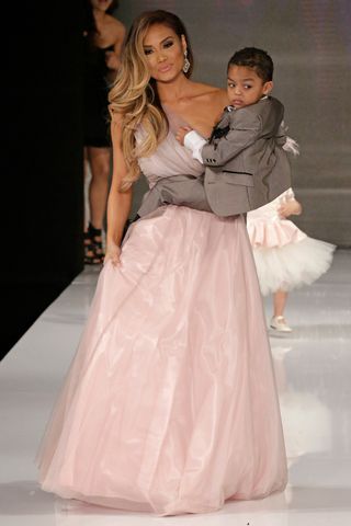 Lawrence K. Ho / Los Angeles Times via Getty Daphne Joy carrying her son Sire Jackson in the Isabella Couture runway show on March 10, 2015 in Hollywood, California.