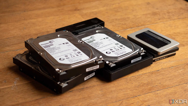 A few HDDs and SSDs, with one HDD inside of a Ugreen HDD enclosure
