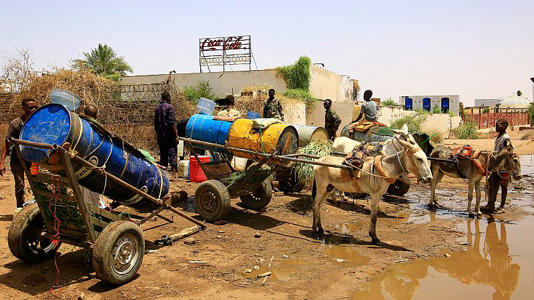 People fill water containers at a distribution point due to water outages in Khartoum, Sudan, Sunday, May 25, 2025. (AP Photo)