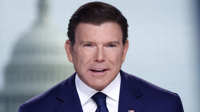 Bret Baier sitting down on his show while wearing a suit and talking