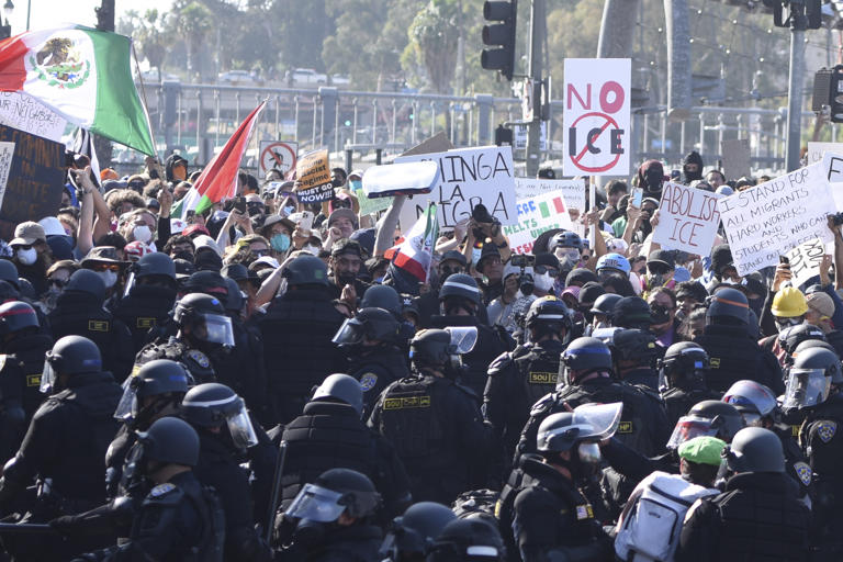 Protesters confront police following recent raids by Immigration and Customs Enforcement (ICE) and Department of Homeland Security (DHS) agents on June 8, 2025 in Los Angeles, California. Sunday marked the third day of unrest as thousands of protesters against recent immigration raids took to the streets of downtown Los Angeles to voice their opposition. Zhang Shuo/China News Service/VCG via AP