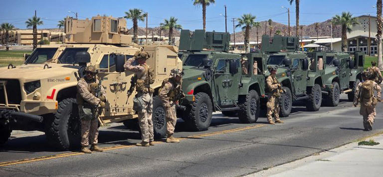 Marines stand near vehicles as they prepare to depart for Los Angeles, at an unknown location, in this handout picture released on June 9, 2025. U.S. Northern Command via X/Handout via REUTERS