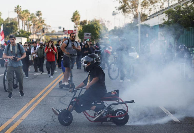 A person burns rubber as people march during a protest against federal immigration sweeps in downtown Los Angeles, California, U.S. June 10, 2025. REUTERS/Leah Millis