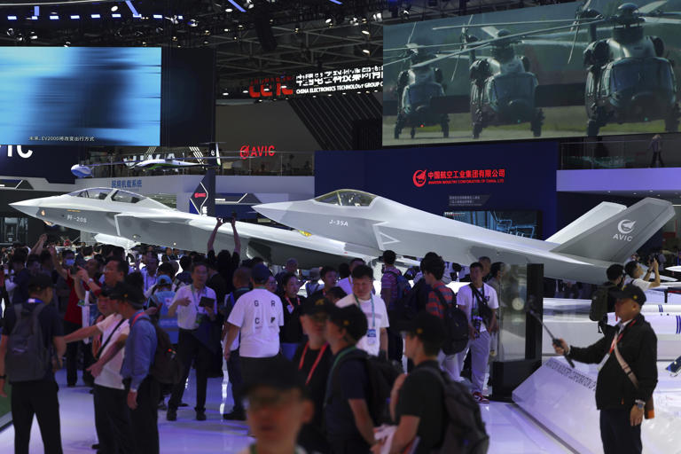 Models of J-35 A, J-20S and other fighter jets are on display at the booth of Aviation Industry Corporation of China., LTD. (AVIC) on day 2 of the 15th China International Aviation and Aerospace Exhibition, or Airshow China 2024, on November 13, 2024 in Zhuhai, Guangdong Province of China. Fu Tian/AP Photo
