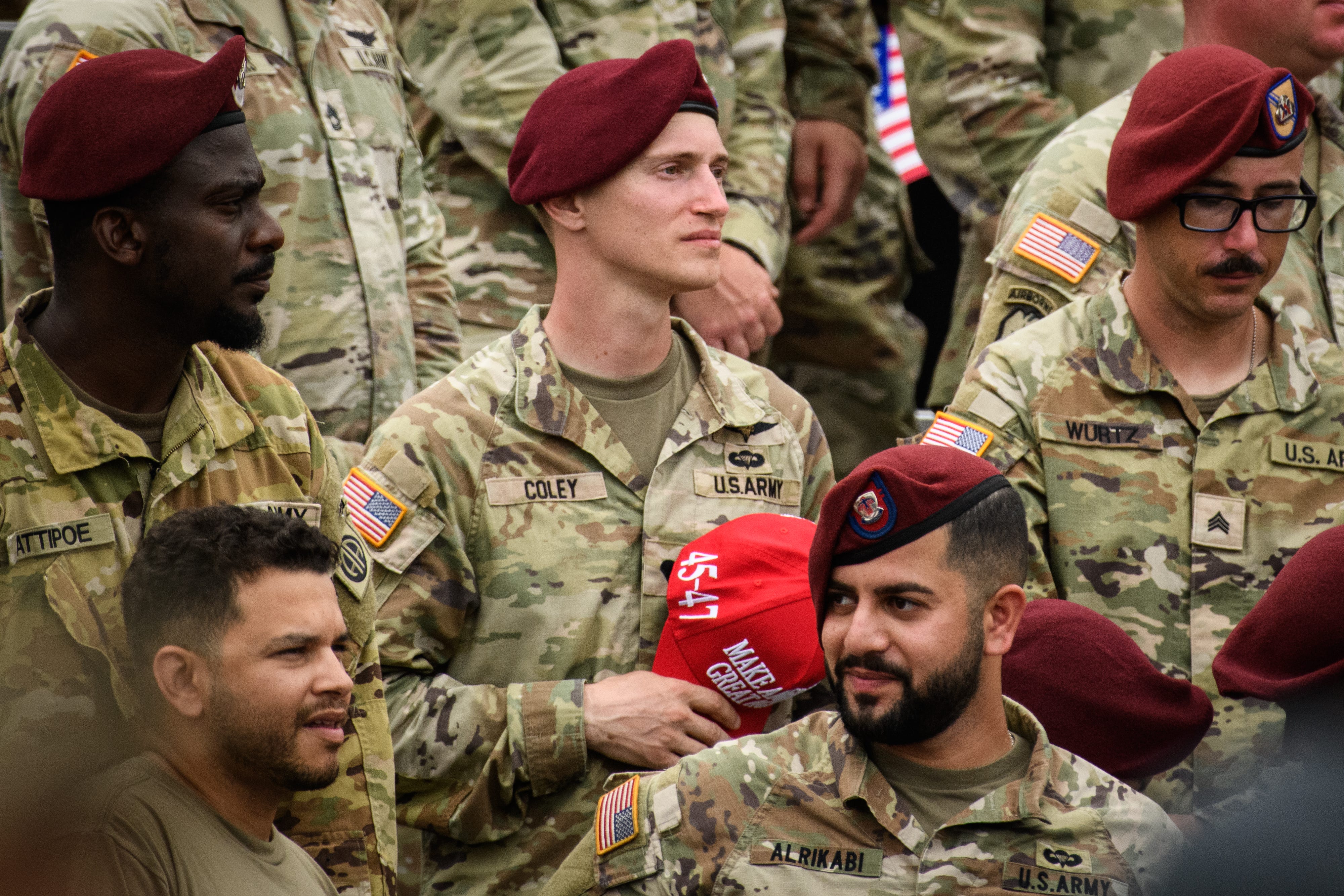 A soldier holds a MAGA hat while he listens to President Donald Trump speak at Fort Bragg on Tuesday, June 10, 2025.