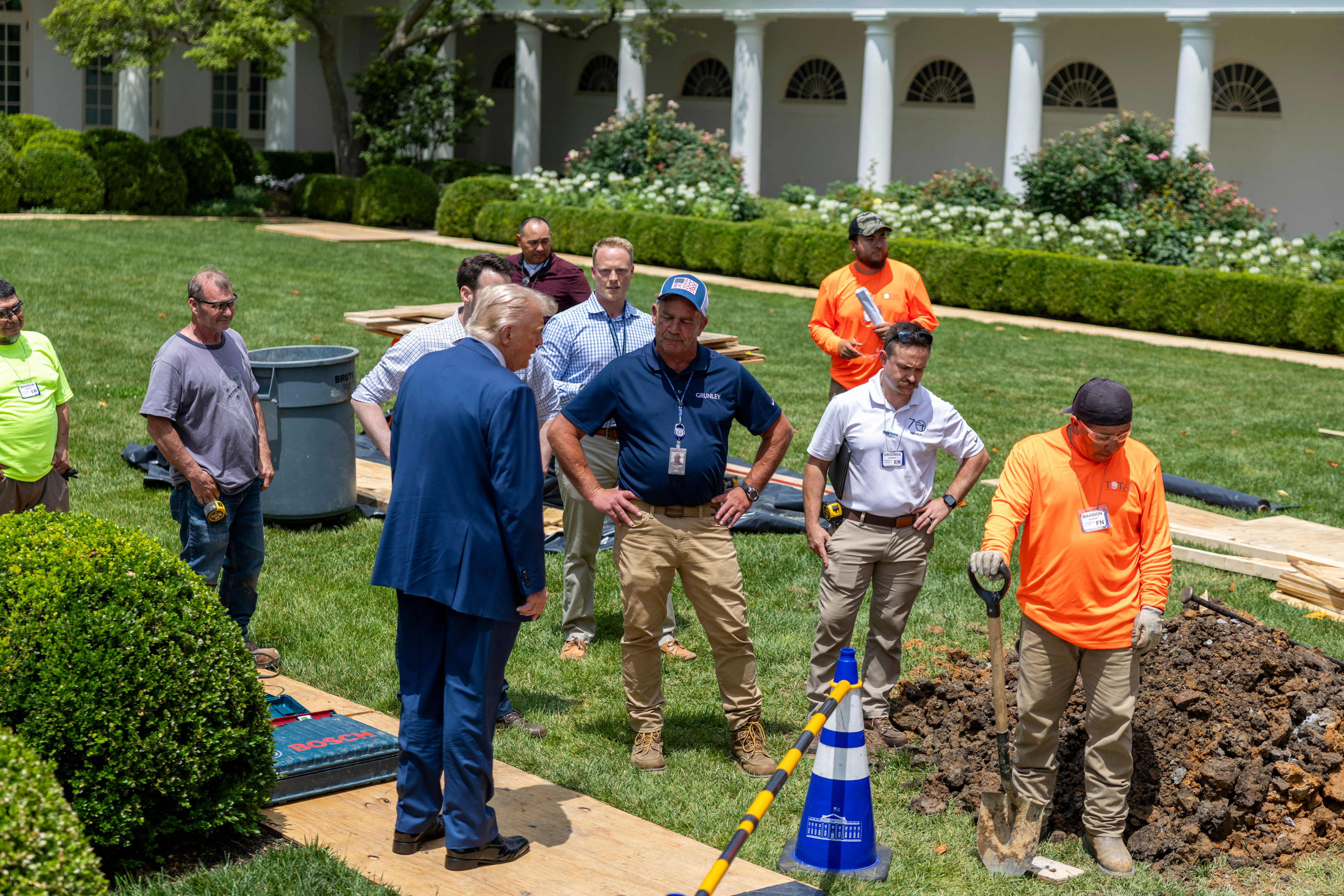 Social media users shared images from June 9, a day after President Donald Trump stumbled, and claimed without evidence that the president is wearing a leg brace. Trump was surveying the construction on the South Lawn (EPA)