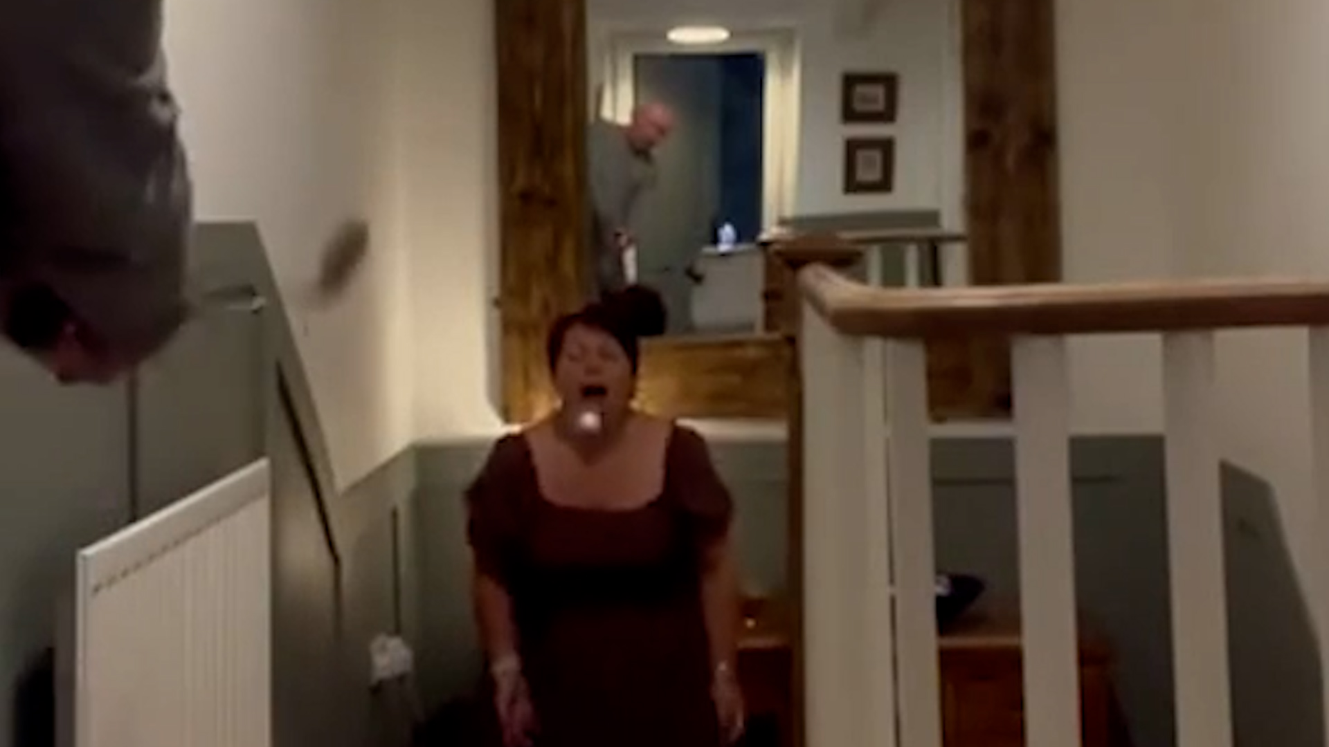 Husband successfully putts marshmallow into wife's mouth